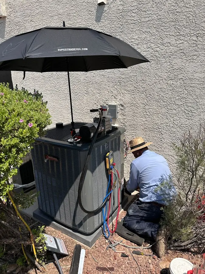 HVAC technician performing outdoor AC maintenance in Roxbury